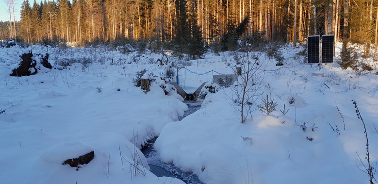 Blick auf die Messstation auf der verschneiten Fläche.